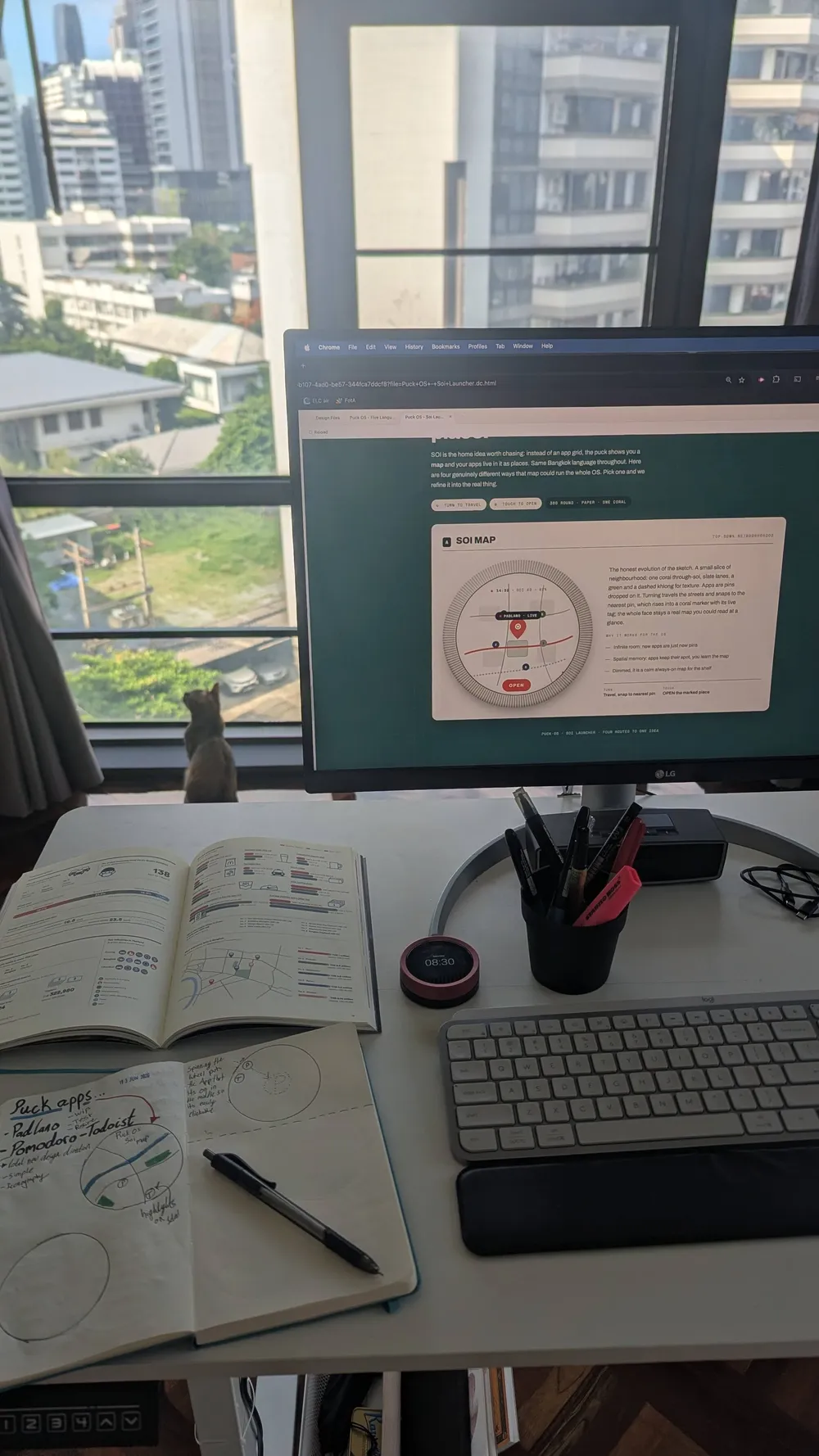 A development desk with device sketches and an interface on-screen