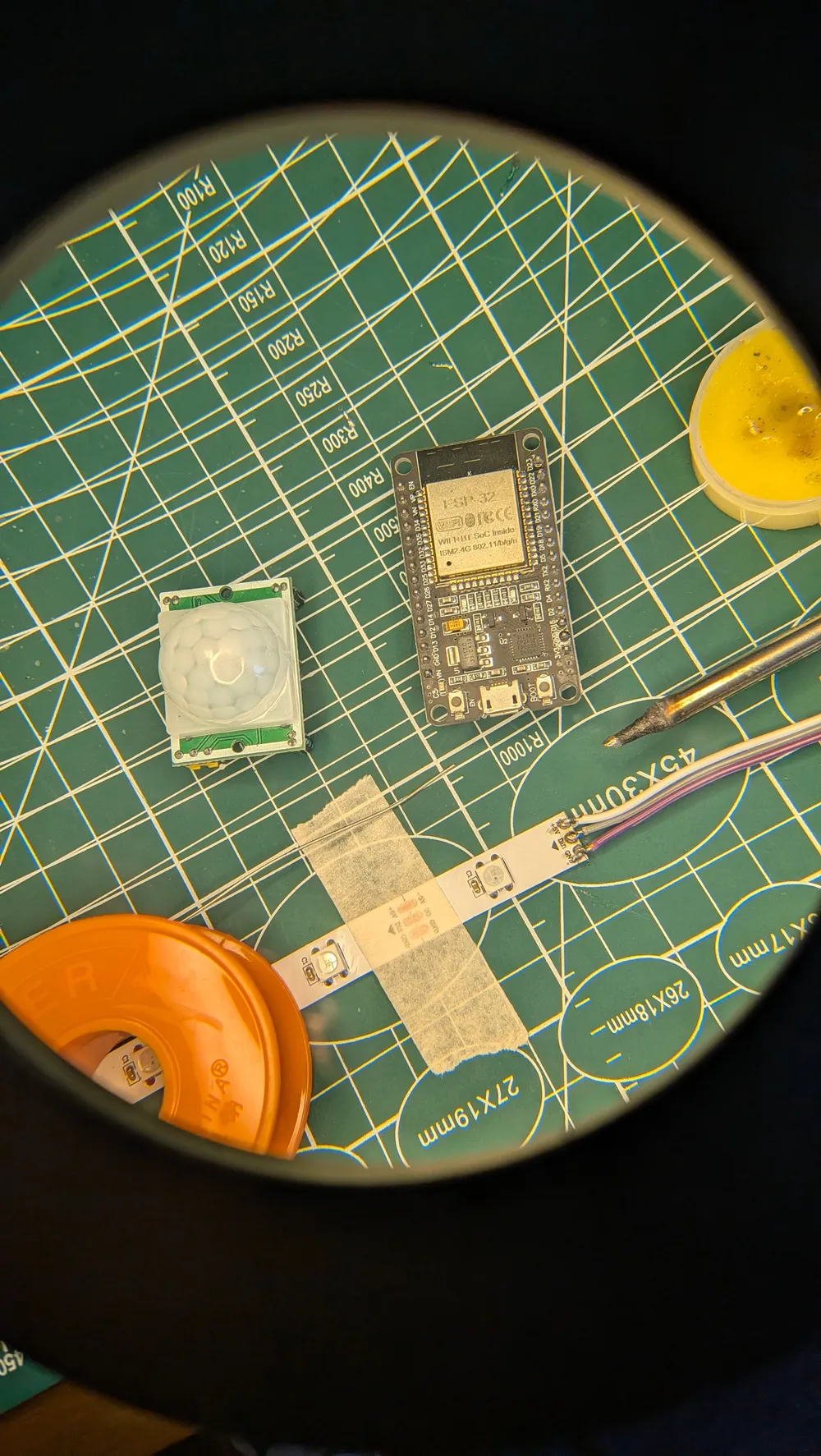 Electronic modules and wiring on a green cutting mat