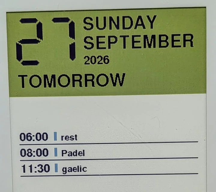 Close view of the E Ink face with the date, TOMORROW label and timed events