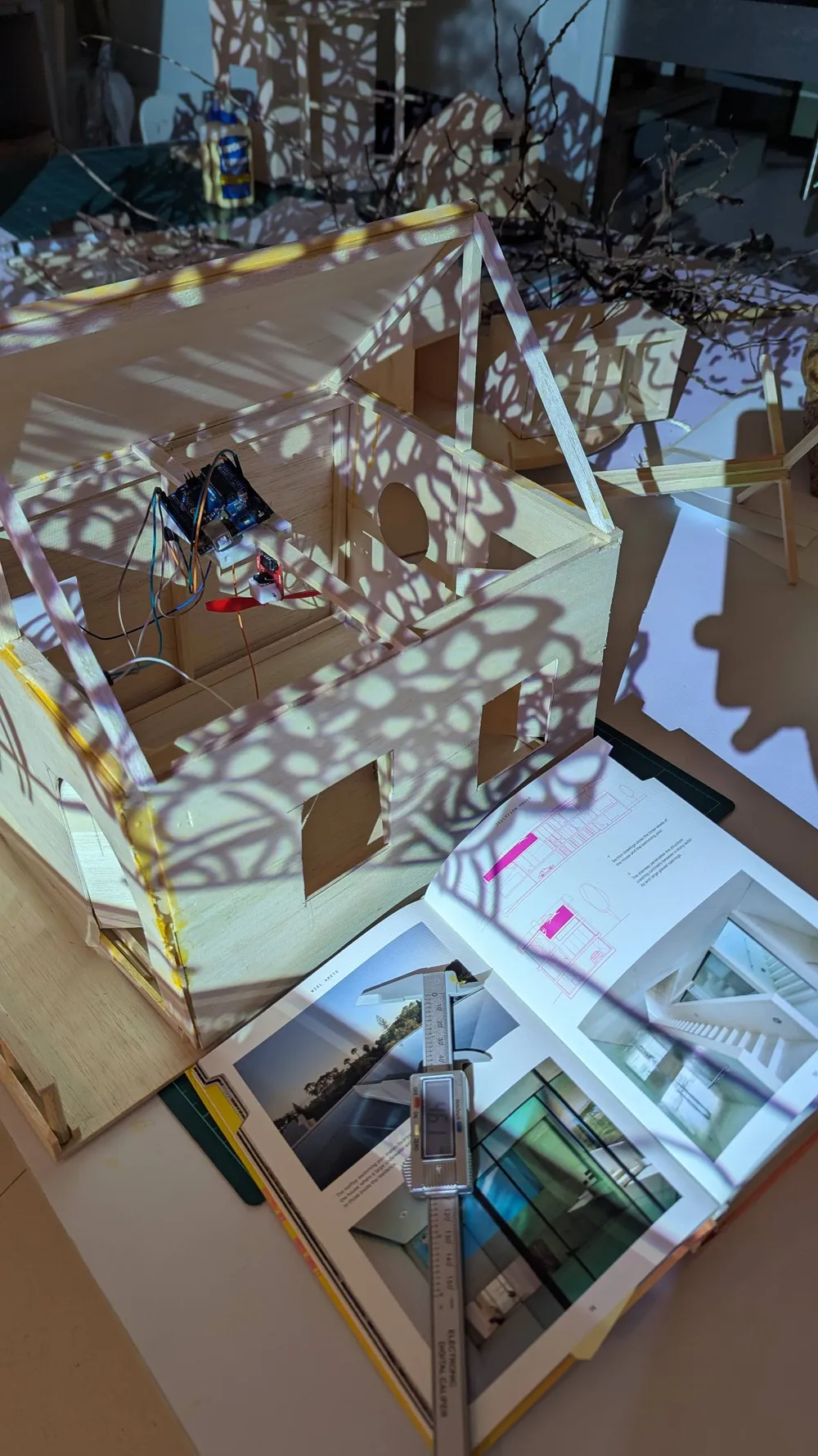 A projected pattern falls across a constructed model
