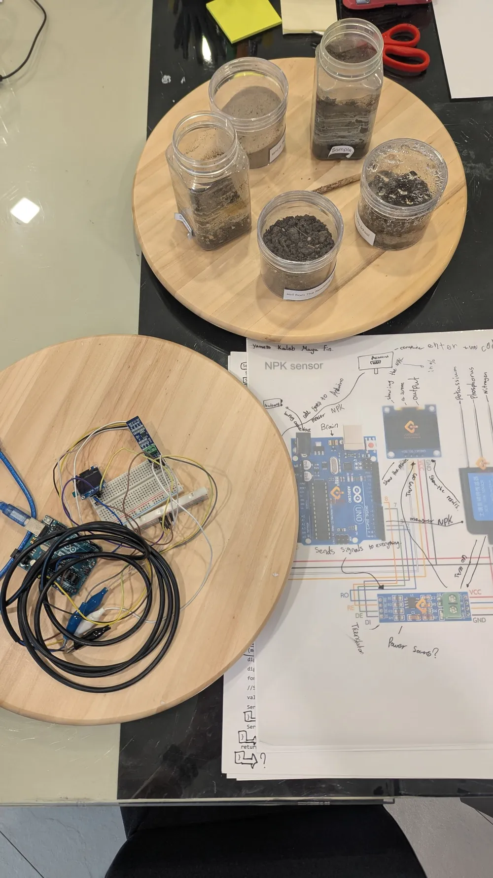 Terrariums sit alongside electronics and project documentation