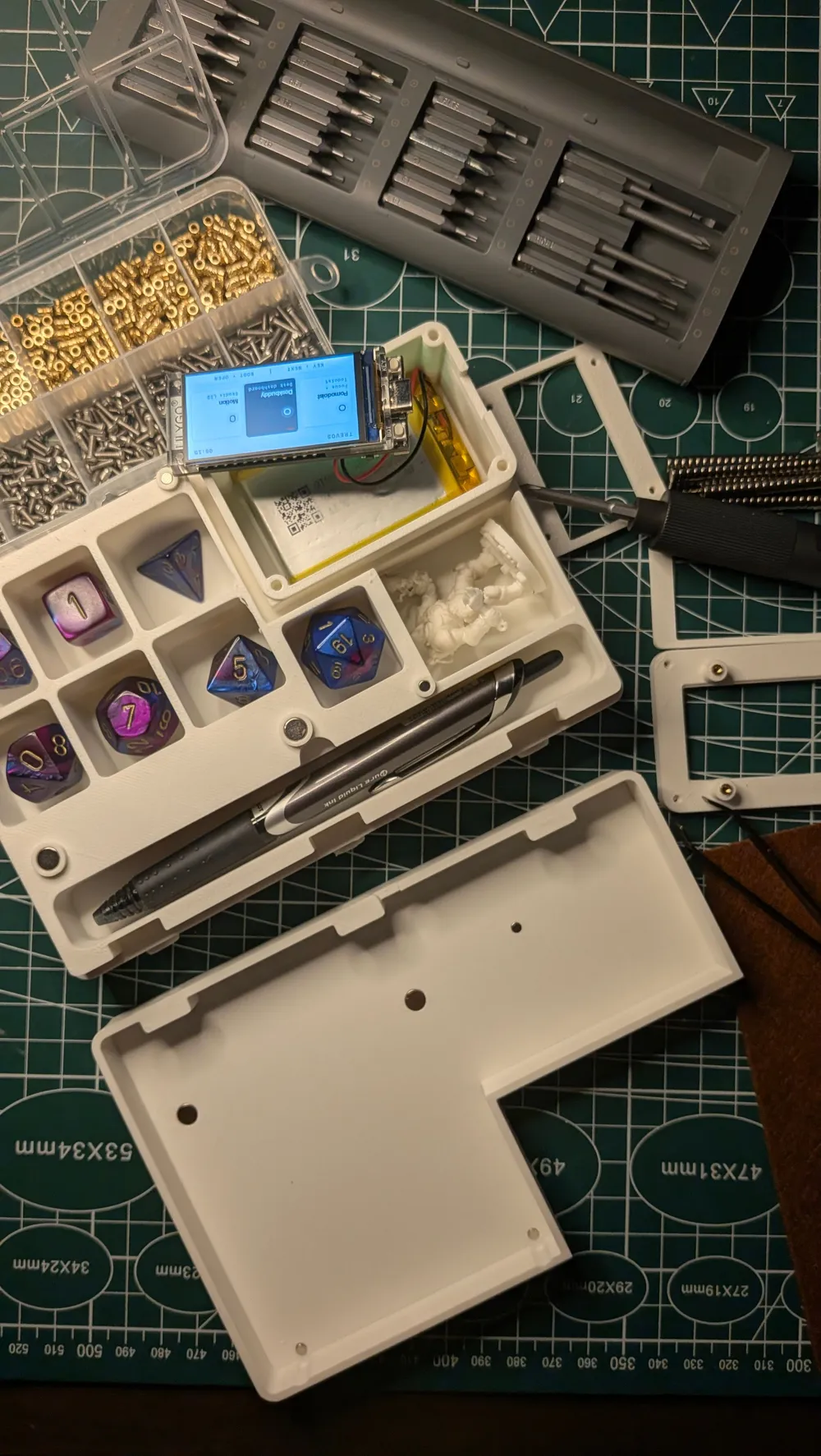 Physical Turnkeep prototype open on the workbench with dice and character components